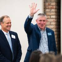 Man waving to group of people